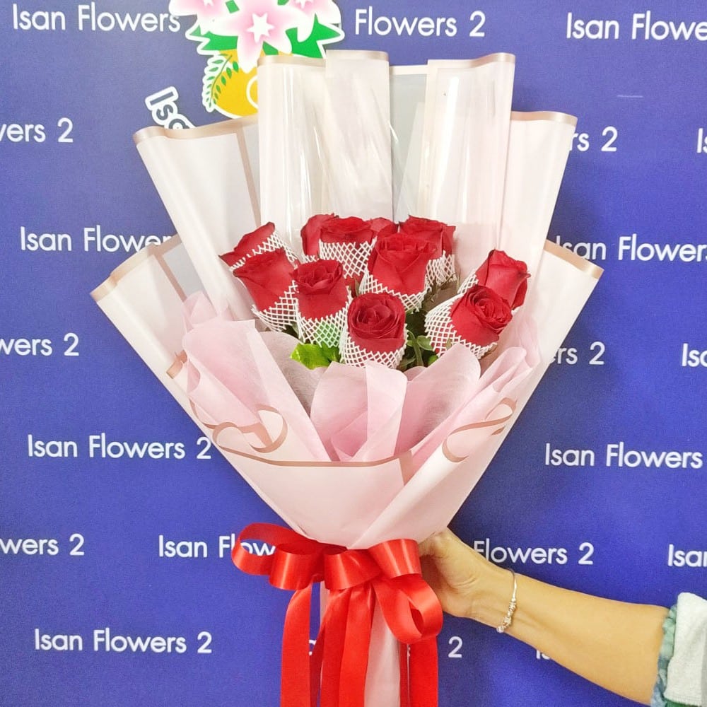 12 big red roses in pink round bouquet a