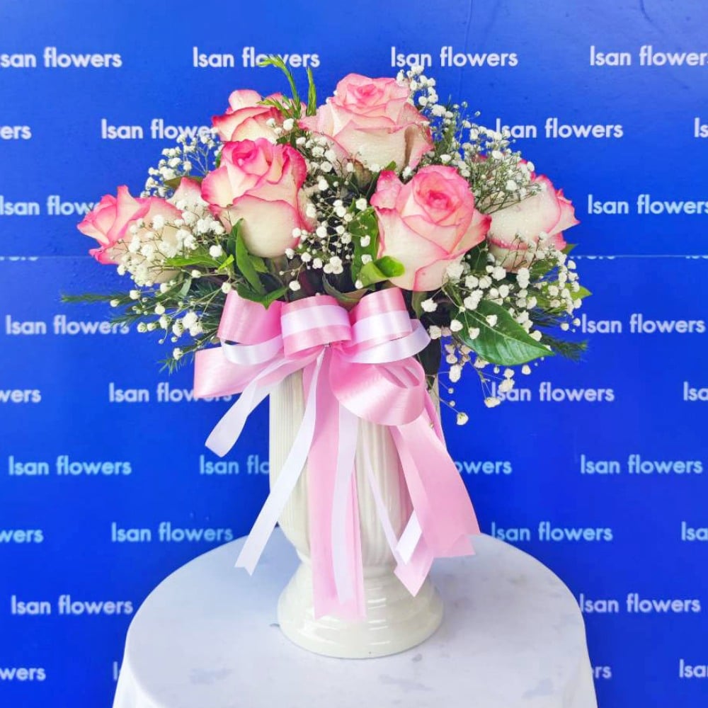 12 pink roses with filler in vase a