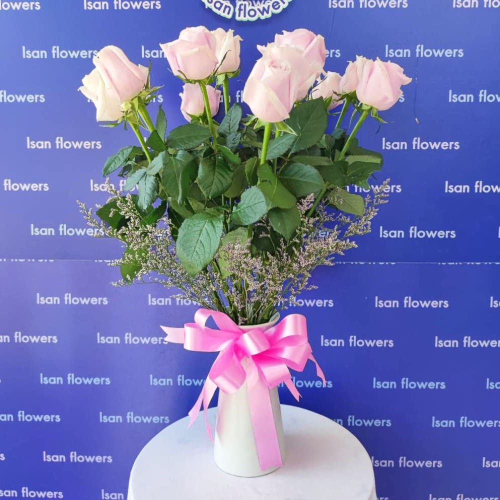 12 pink roses with filler in vase b pre