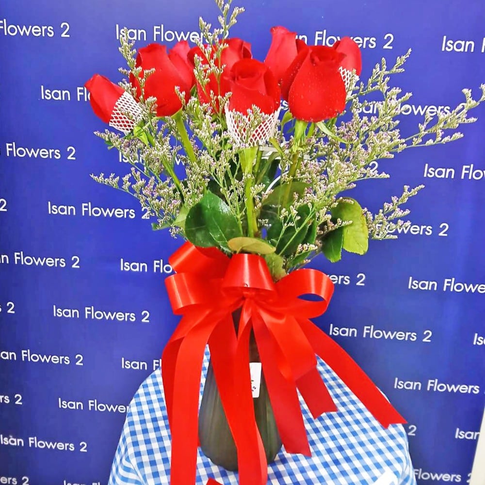 12 red roses with filler in vase a pre