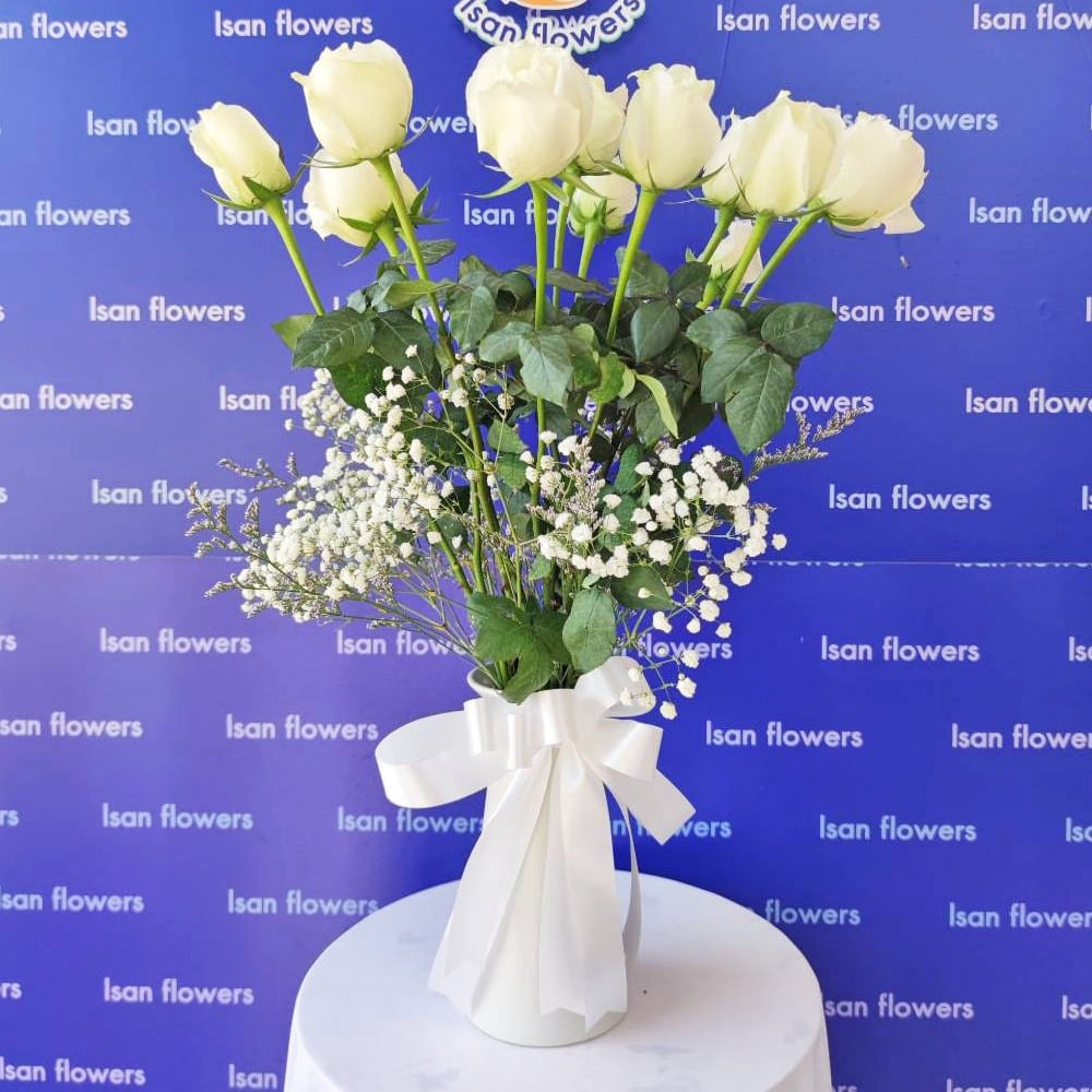 12 white roses with filler in vase a pre