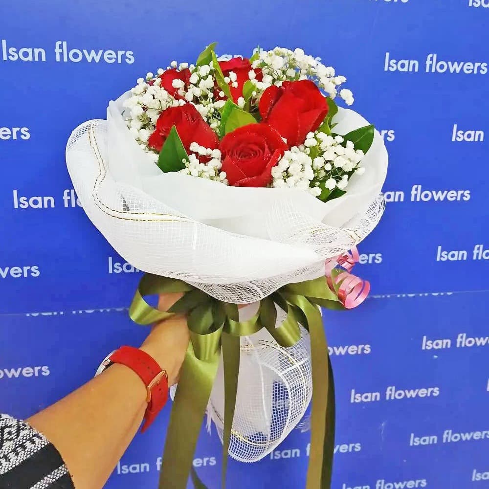 9 big red roses in white round bouquet a