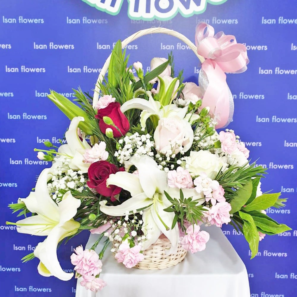 white lilies with mixed flowers basket a large pre